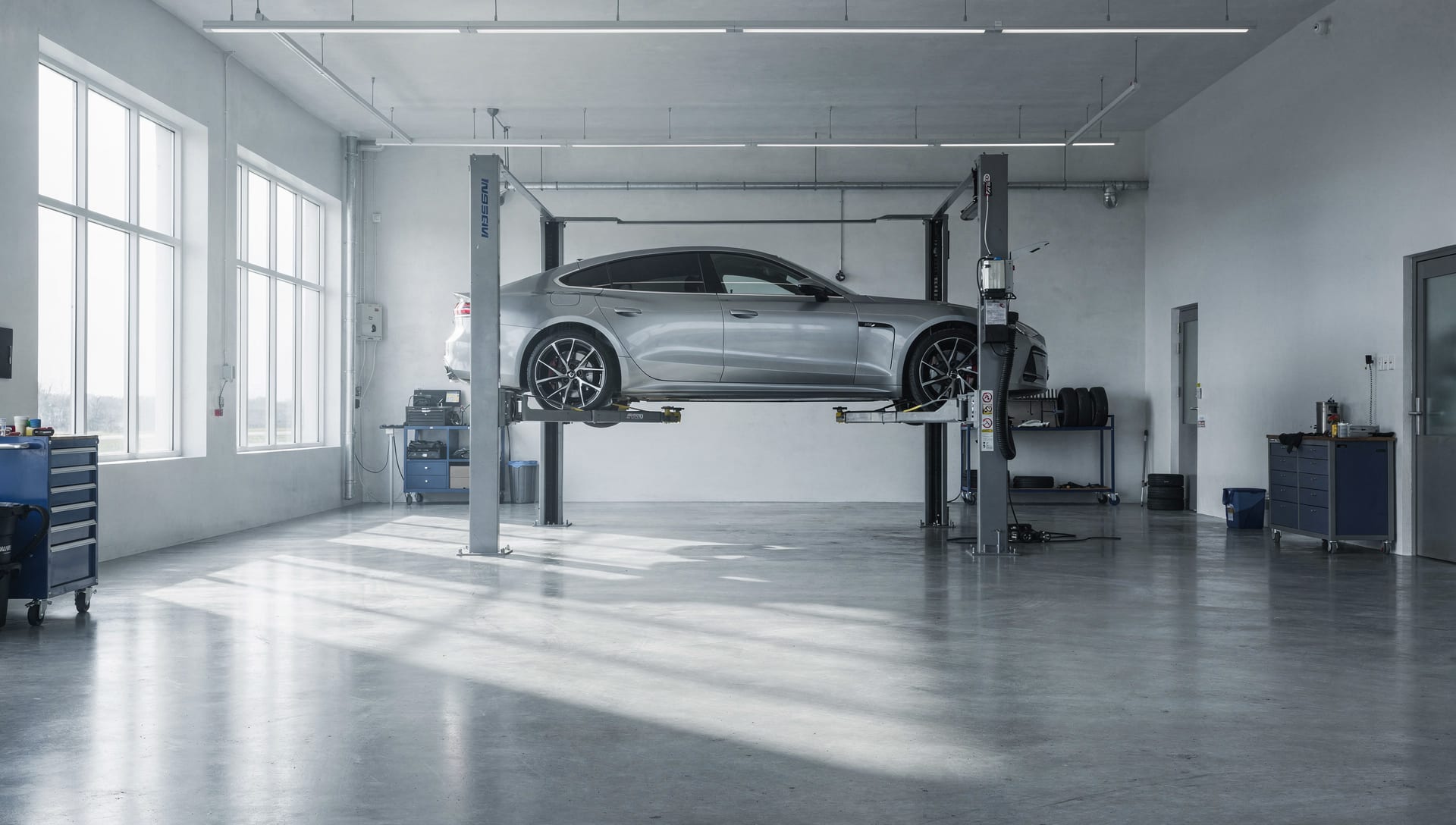 A car raised on a lift in a clean, calm service bay
